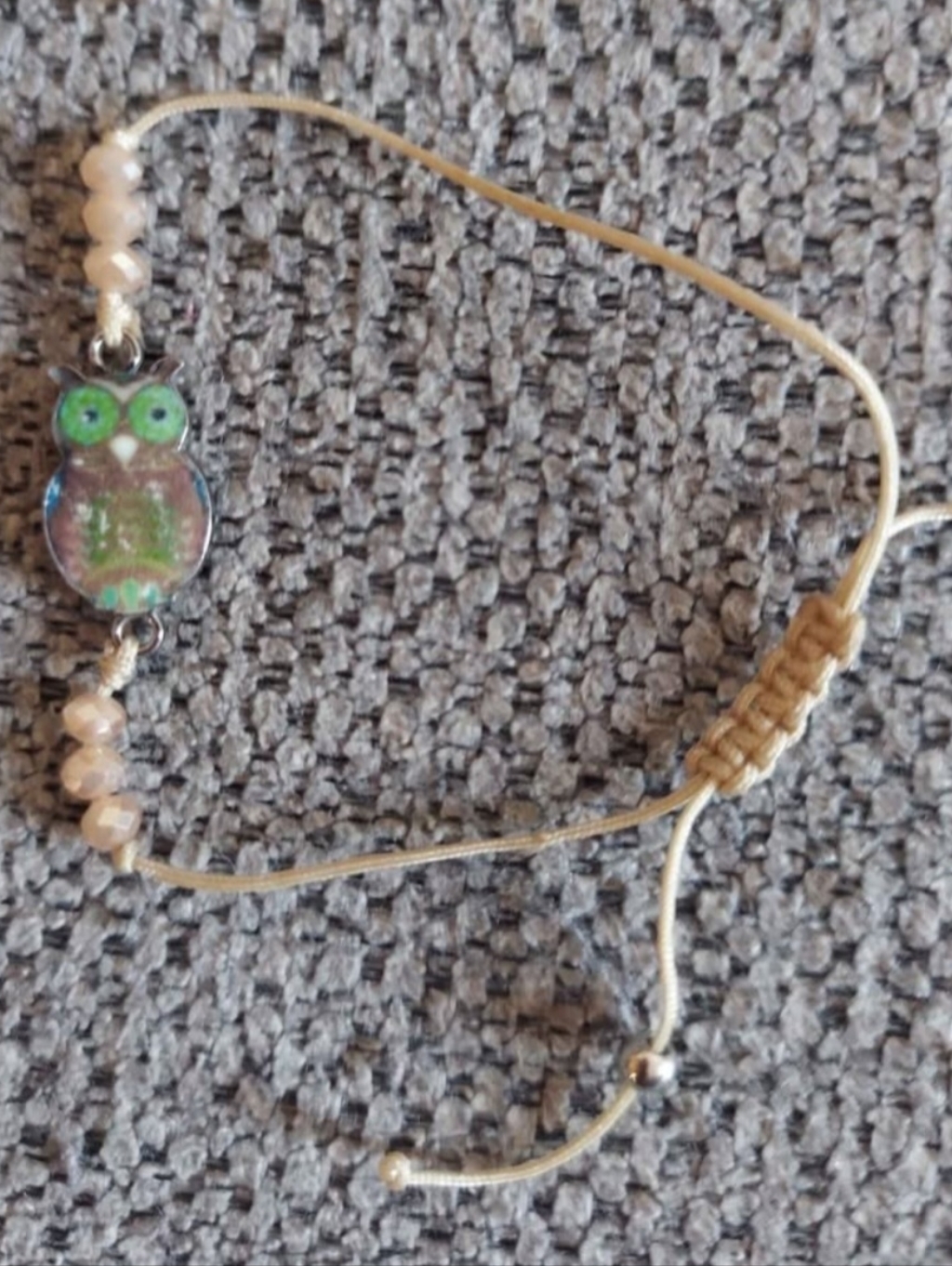 Green-Eye Owl Charm Bracelet On Cream Cord